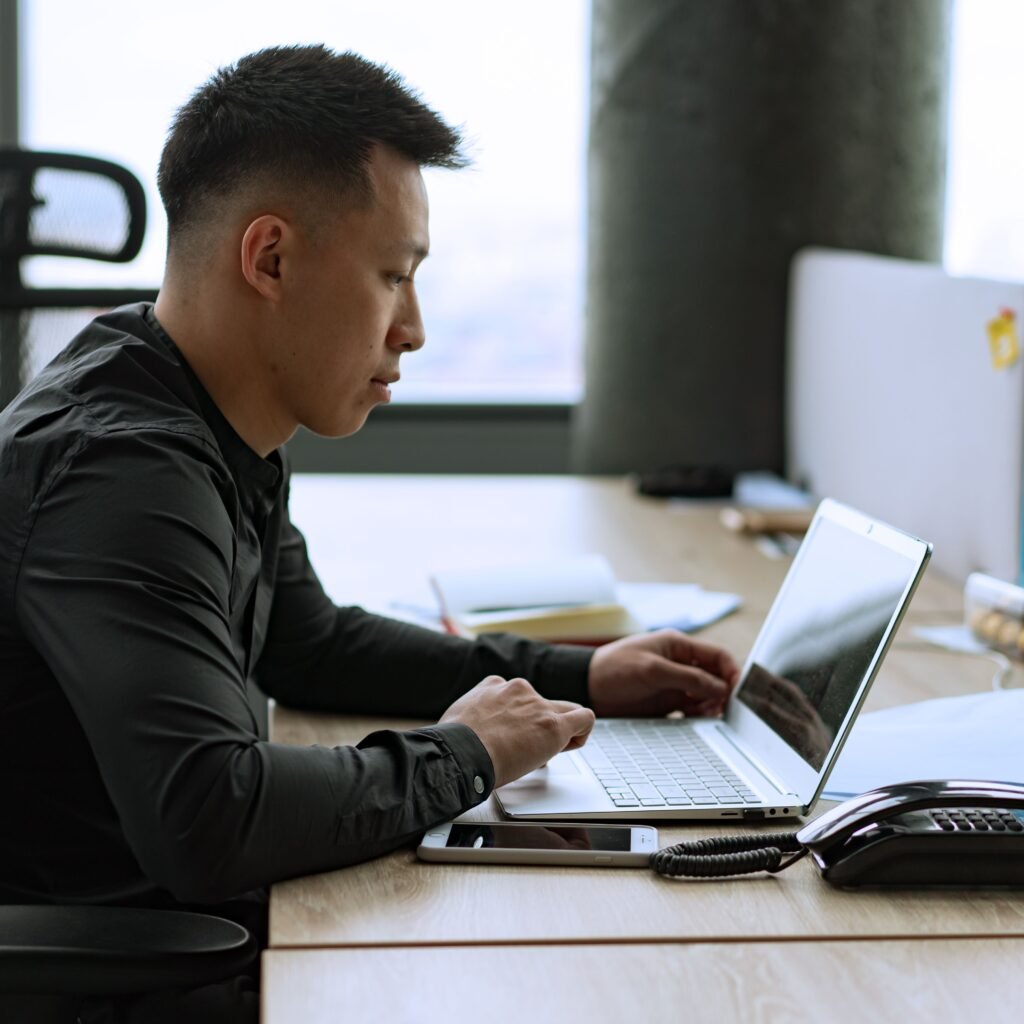 Business owner using AI for small business productivity on a laptop