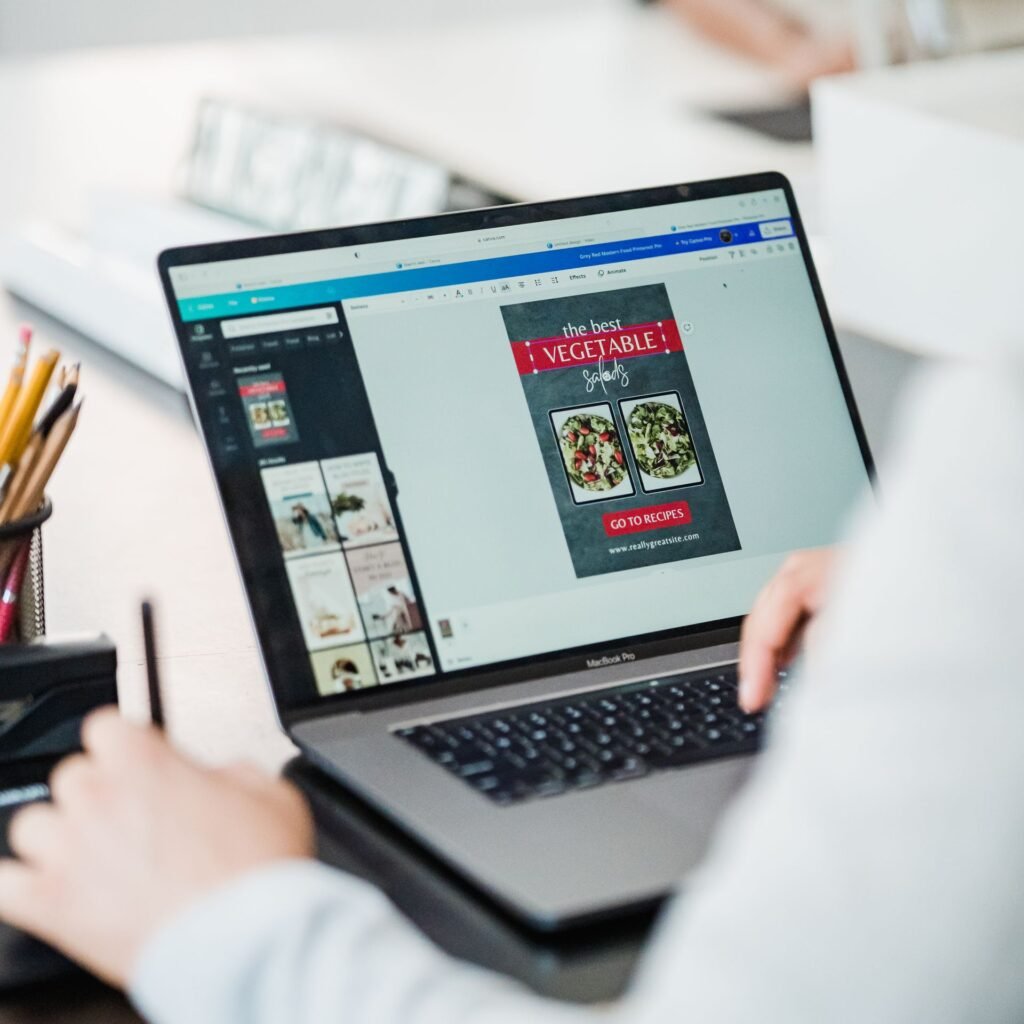 “Creating a digital product in Canva on a laptop”